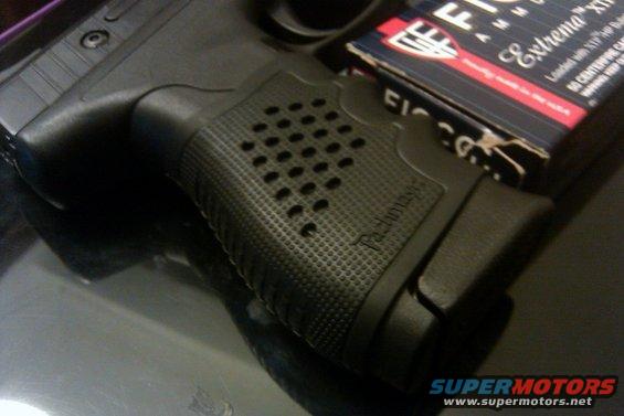 Black pistol grip with textured pattern and a box of Fiocchi Extrema ammunition