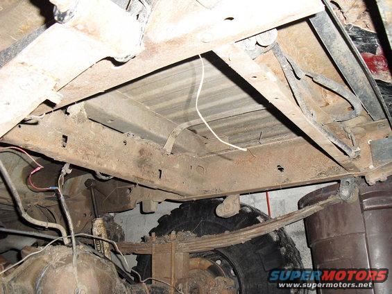 Undercarriage view of rusty truck frame and leaf springs