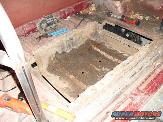 Interior floor pan with rust and tools