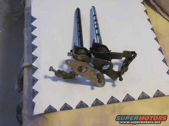 Two old door lock actuator assemblies with rods and mounting plates