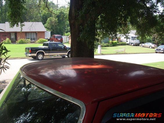 Black Ford F-250 Super Duty pickup truck parked on street. Another vehicle is visible in the foreground