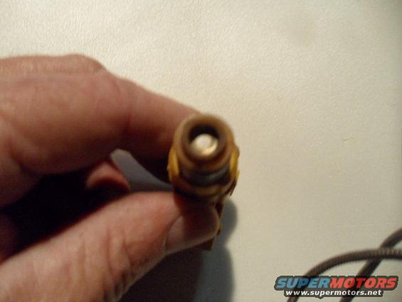 Spark plug held by a hand