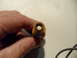 1973 Ford Ranchero - A hand holds a spark plug, showing its internal components.