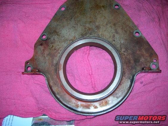 Engine timing cover with a large central opening and mounting holes