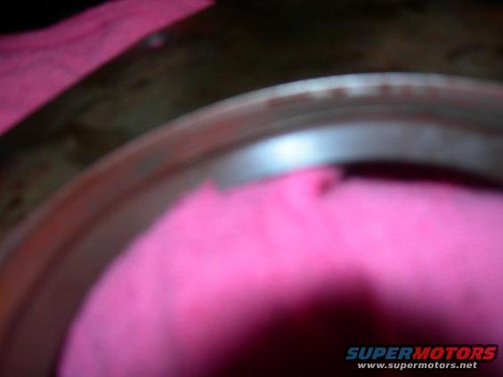Close-up of a metal wheel rim partially covered by pink fabric