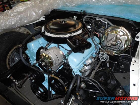 1973 Pontiac Trans Am engine bay with light blue valve covers, black air cleaner, and chrome alternator