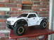 1988 Ford Bronco - Remote control truck with off-road tires and custom graphics sits on a table.