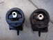 2003 Ford Taurus - Comparison of a new engine mount next to a used one, likely for a vehicle part replacement.