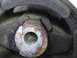 2003 Ford Taurus - This engine mount shows significant wear and tear, with the rubber component appearing to be torn and the metal parts showing rust.