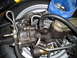1973 Ford Ranchero - Power steering gearbox and brake master cylinder assembly with associated hoses and a tire in the background.