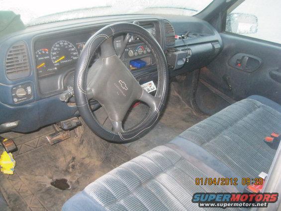 Interior view of a 1995 Chevrolet C/K pickup truck, showing the dashboard, steering wheel, and seats