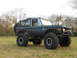 1967 Ford Mustang - This lifted Ford Bronco features oversized tires and a spare tire mounted on the rear.