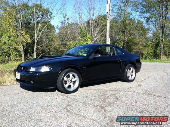 Black 2002 Ford Mustang coupe parked on asphalt