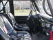1967 Ford Mustang - Interior view of a modified vehicle with racing seats and a roll cage, showing the dashboard and gear shifters.