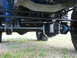1967 Ford Mustang - Close-up of the heavy-duty suspension and drivetrain components of an off-road vehicle.