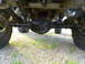 1967 Ford Mustang - Undercarriage view of a vehicle's rear axle, leaf springs, and shock absorbers.