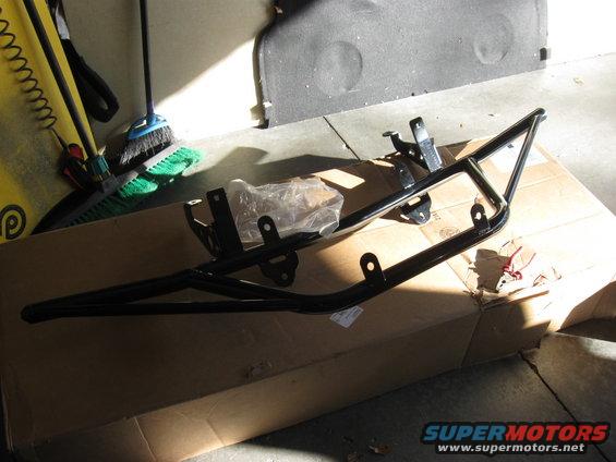 Black metal light bar part on cardboard box
