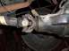 1989 Ford Bronco - Underside view of a vehicle's rear axle and driveshaft components, showing wear and grease.