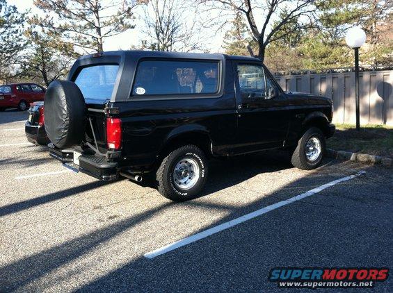 black 1996 Ford Bronco parked, spare tire on back