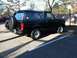 1996 Ford Bronco - A black 1996 Ford Bronco is parked in a lot with a spare tire mounted on the rear.