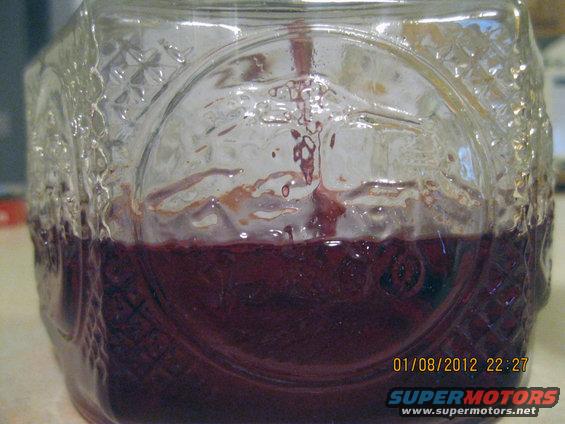 Glass jar with dark red liquid inside. Date stamp reads 01/08/2012