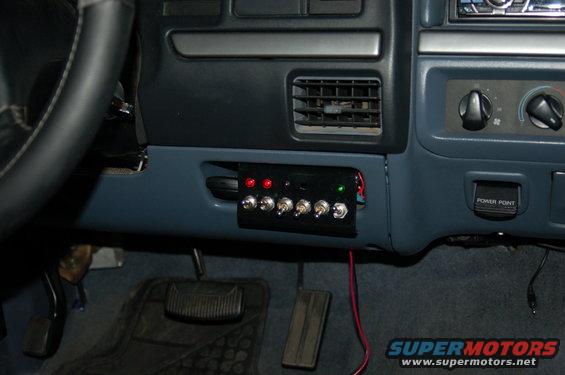 1992 Ford F-150 interior with aftermarket switch panel, red and green indicator lights, and a power point