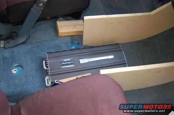 Car interior with an Audiopipe 1500W amplifier and custom wood paneling installed