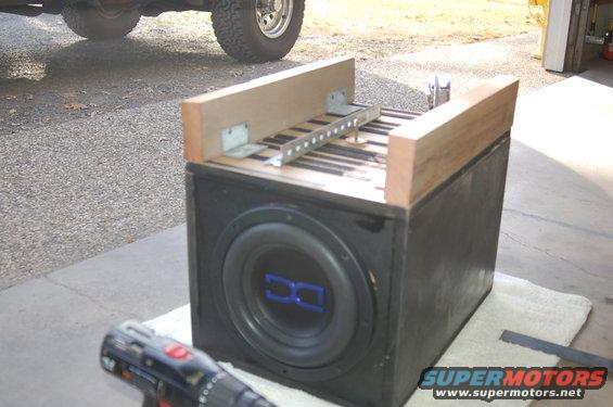 Subwoofer box with wooden frame and drill in foreground