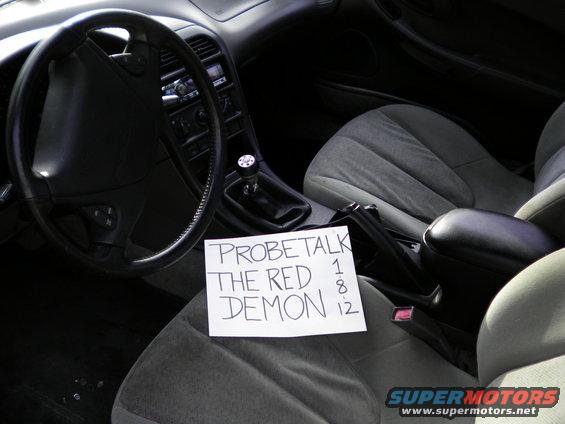 Interior view of a car with a handwritten note that says "PROBETALK THE RED DEMON 1 8 12"