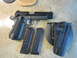 1972 Ford Bronco - A handgun, two spare magazines, and a tactical holster are laid out on a textured surface.