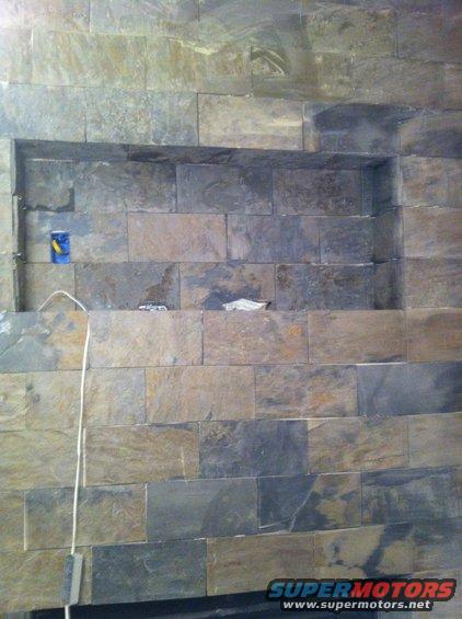 Stone wall with recessed shelf and electrical outlet