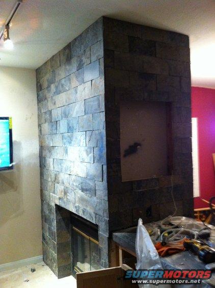 stone fireplace under construction, tools on counter