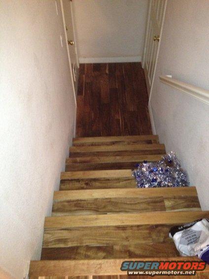 wooden staircase with blue tinsel on steps