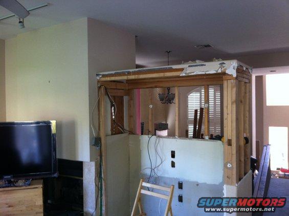 Interior of a house under renovation with exposed framing and wiring