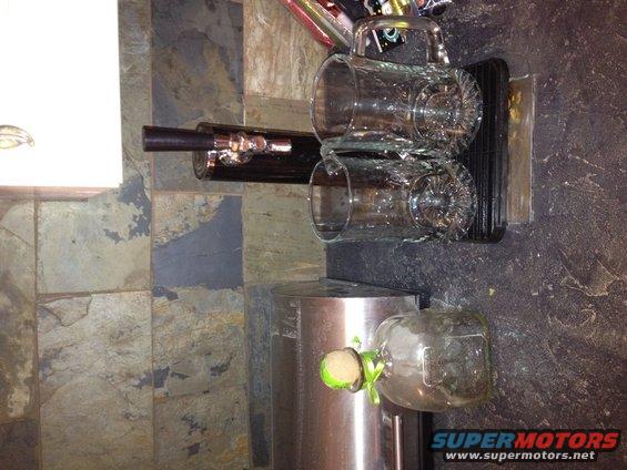Beer tap with two mugs and a bottle