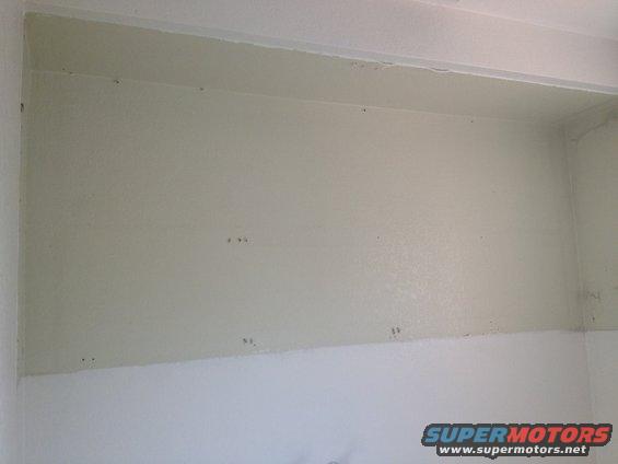 Interior wall with painted finish and some small marks, Supermotors.net logo in lower right