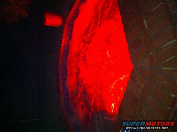 red light fixture on a dark, textured surface