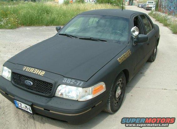 Black 2003 Ford Crown Victoria police car with "SHERIFF" text