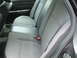 2003 Ford Crown Victoria - Interior view of the rear seating area, showing fabric upholstery and seatbelts.