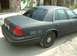 2003 Ford Crown Victoria - Rear quarter view of a matte black 2003 Ford Crown Victoria police car with 'SHERIFF' and 'CALL 911' markings.