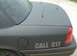2003 Ford Crown Victoria - This 2003 Ford Crown Victoria, likely a police interceptor, features a matte black finish and multiple antennas on its roof.