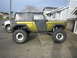 1974 Ford Bronco - Modified 1974 Ford Bronco with custom paint and off-road tires is parked on a driveway.