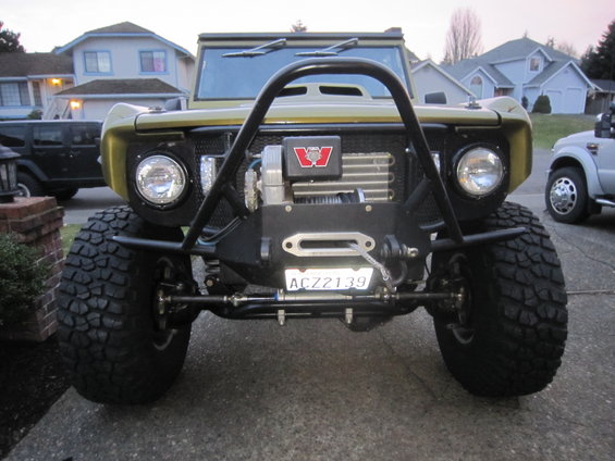 Front view of a modified SUV with large tires and a winch. License plate ACZ2139 is visible