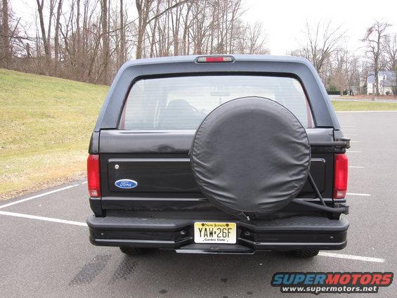 Rear view of a black 1996 Ford Bronco with a spare tire mounted on the back. New Jersey license plate YAW-26F