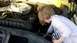 1978 Ford Bronco - A child explores the engine compartment of a vehicle.