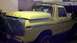 1978 Ford Bronco - A yellow 1978 Ford Bronco is parked in a garage, partially covered by a green tarp.