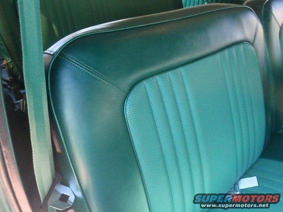 green vinyl and cloth bench seat interior with seatbelt