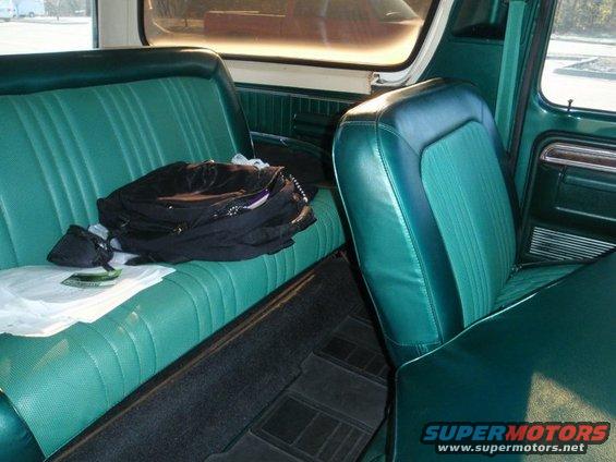 Green interior of a 1978 Ford Bronco with bench seat and bucket seat