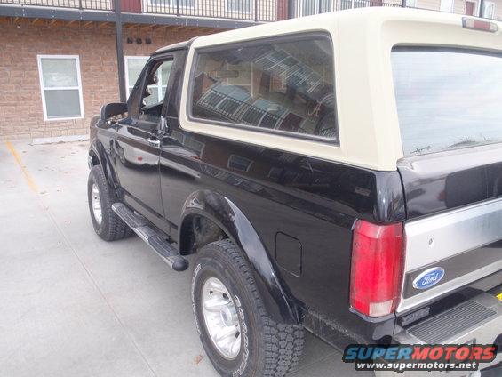 Black 1994 Ford Bronco, 3/4 front view, tan top