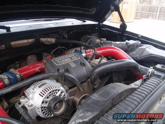 Engine bay with "POWER STROKE TURBO 7.3L" label and red piping